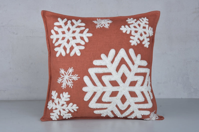 Burnt orange cotton pillow cover with off-white embroidered snowflake and pearl beads