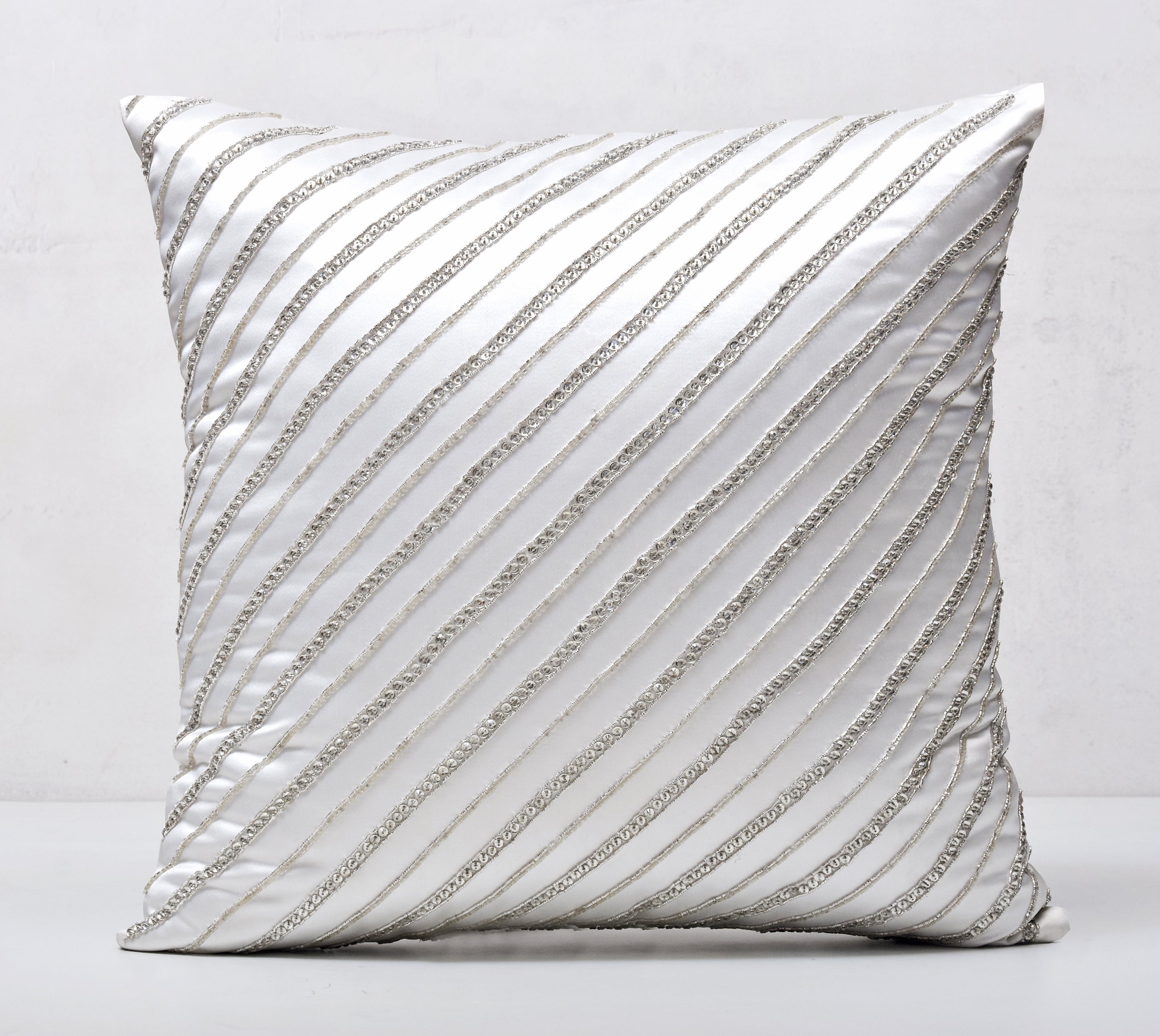 silver and white decorative pillows